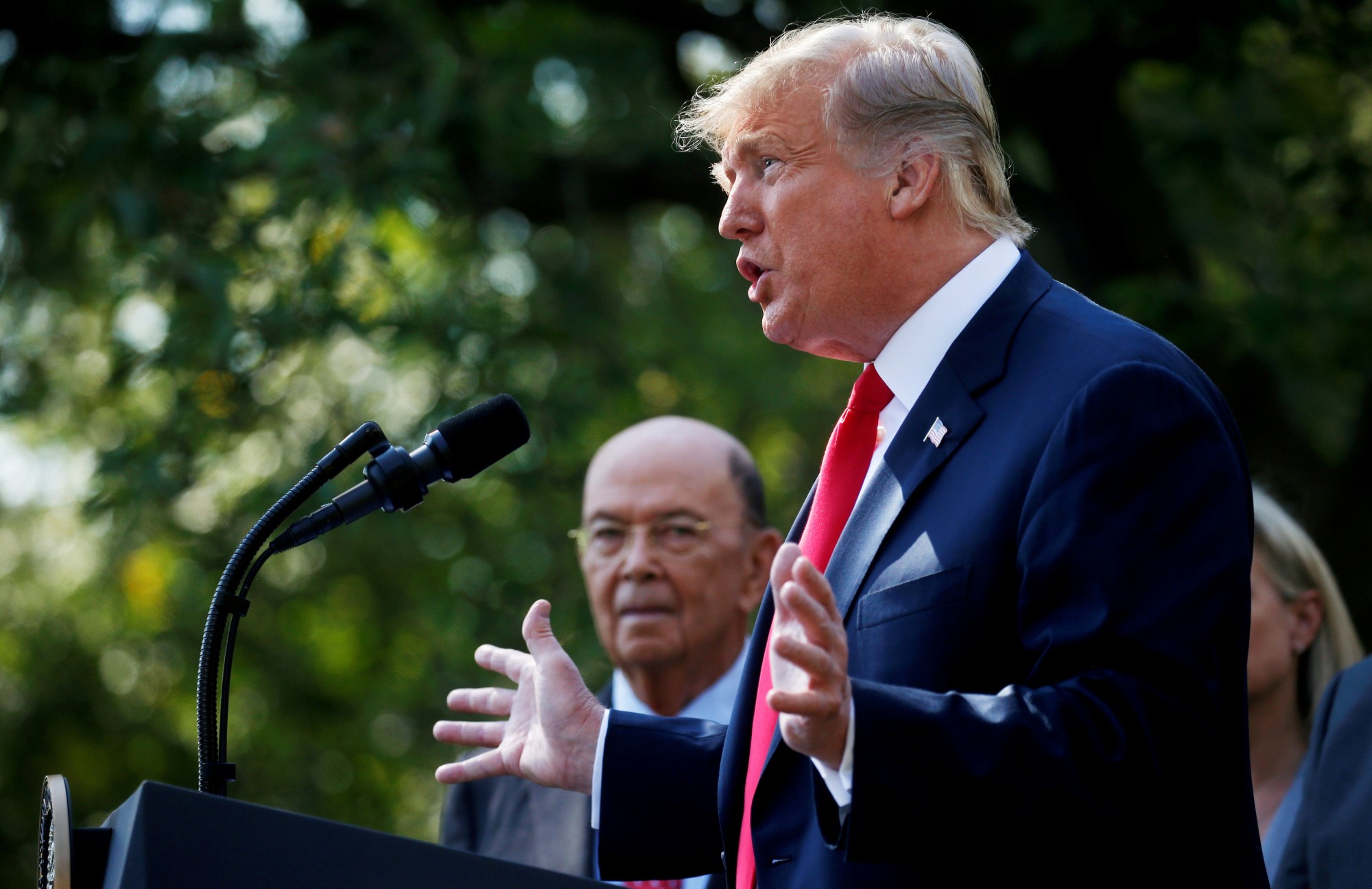 U.S. President Donald Trump announces the United States-Mexico-Canada Agreement (USMCA) as U.S. Commerce Secretary Wilbur Ross looks on during a news conference in the Rose Garden of the White House in Washington last October. | REUTERS