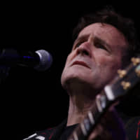 Musician Johnny Clegg performs on stage during his own farewell concert in Johannesburg in 2017. Clegg died at his home in Johannesburg Tuesday after suffering from pancreatic cancer. | AP