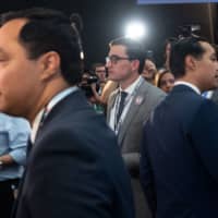 Democratic presidential hopeful former Housing and Urban Development Secretary Julian Castro (right) and his twin brother, U.S. Rep. Joaquin Castro, Democrat of Texas, speak with the press in the Spin Room after participating in the first Democratic primary debate of the 2020 presidential campaign season hosted by NBC News at the Adrienne Arsht Center for the Performing Arts in Miami June 26. | AFP-JIJI
