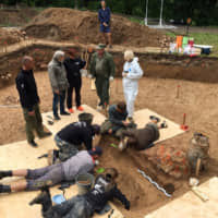 Archaeologists take part in excavation work after they discovered what they believe to be the burial site of French Gen. Charles Etienne Gudin in a park in Smolensk, Russia, in this handout picture obtained by Reuters on Tuesday. | SMOLENSK NEWSPAPER \'RABOCHY-PUT.RU\' / HANDOUT / VIA REUTERS