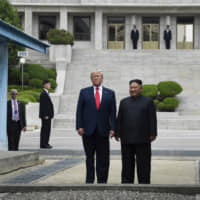 U.S. President Donald Trump and North Korean leader Kim Jong Un stand on the North Korean side of the Demilitarized Zone in Panmunjom on June 30. | AP