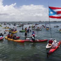Demonstrators in kayaks gather in front of La Fortaleza for an aquatic protest against Puerto Rico Gov. Ricardo Rossello in San Juan Sunday. | AP