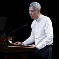 Lee Hsien Yang, son of former leader Lee Kuan Yew, delivers his eulogy during a funeral service at the University Cultural Centre at the National University of Singapore in 2015. | REUTERS