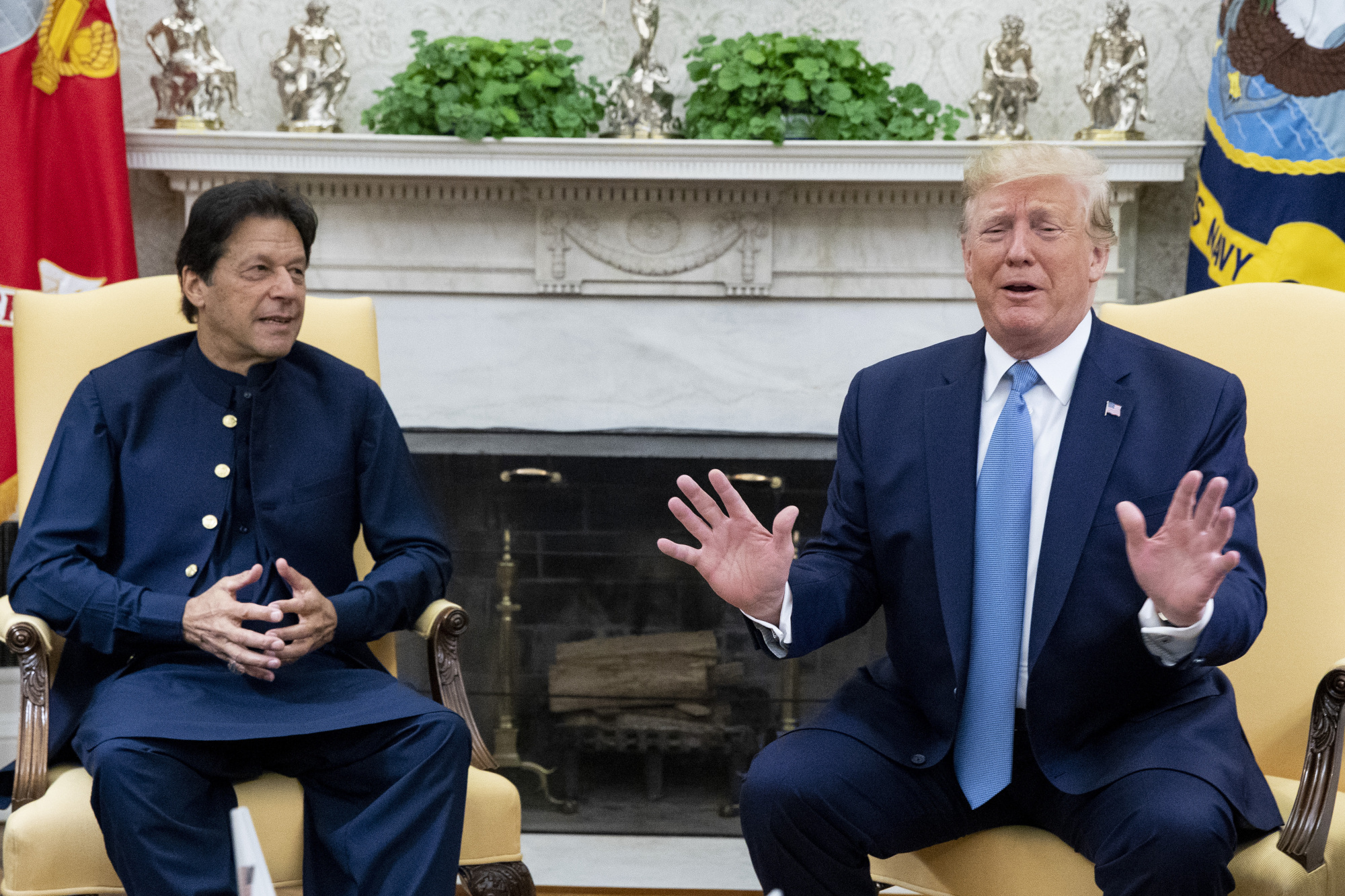 U.S. President Donald Trump speaks while Imran Khan, Pakistan's prime minister, listens during a meeting in the Oval Office of the White House in Washington on Monday. | BLOOMBERG
