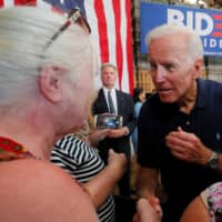 Democratic 2020 U.S. presidential candidate and former U.S. Vice President Joe Biden greets audience members during a campaign stop at Mack\'s Apples in Londonderry, New Hampshire, Saturday. | REUTERS