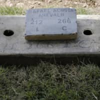 The grave of Navy Capt. Rafael Acosta lies at the East cemetery in Caracas Wednesday. Acosta, who died of suspected torture while in government custody, was buried by authorities against the family\'s wishes to perform a private ceremony, an attorney and relatives said. | AP