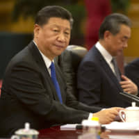 Chinese President Xi Jinping sits during a meeting with Turkish President Recep Tayyip Erdogan at the Great Hall of the People in Beijing on July 2. | AP