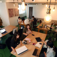 People gather at Kamejima Garage, a coworking space in Nagoya\'s Nakamura Ward for entrepreneurs and students seeking to start a business. | CHUNICHI SHIMBUN