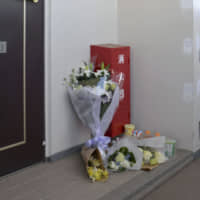 Flowers are seen Feb. 4 in front of an apartment in Noda, Chiba Prefecture, where Mia Kurihara, who died in January after being abused by her father, used to live. | KYODO
