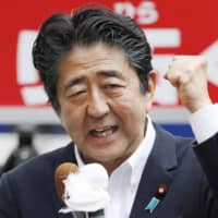 Prime Minister Shinzo Abe gestures while delivering a stump speech for Sunday\'s Upper House election in Yokkaichi, Mie Prefecture, on Thursday. | KYODO