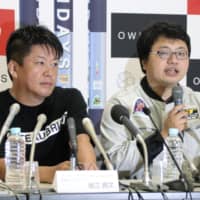 Takafumi Horie (left), founder of Interstellar Technologies Inc., and Takahiro Inagawa, the aerospace startup\'s president, attend a news conference in Taiki, Hokkaido, on Saturday. | KYODO