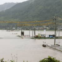 Rice paddies are seen flooded Monday after heavy rains in the town of Mashiki, Kumamoto Prefecture. | KYODO