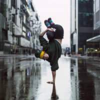 Go for gold: A breakdancer performs on the streets of Moscow. | GETTY IMAGES