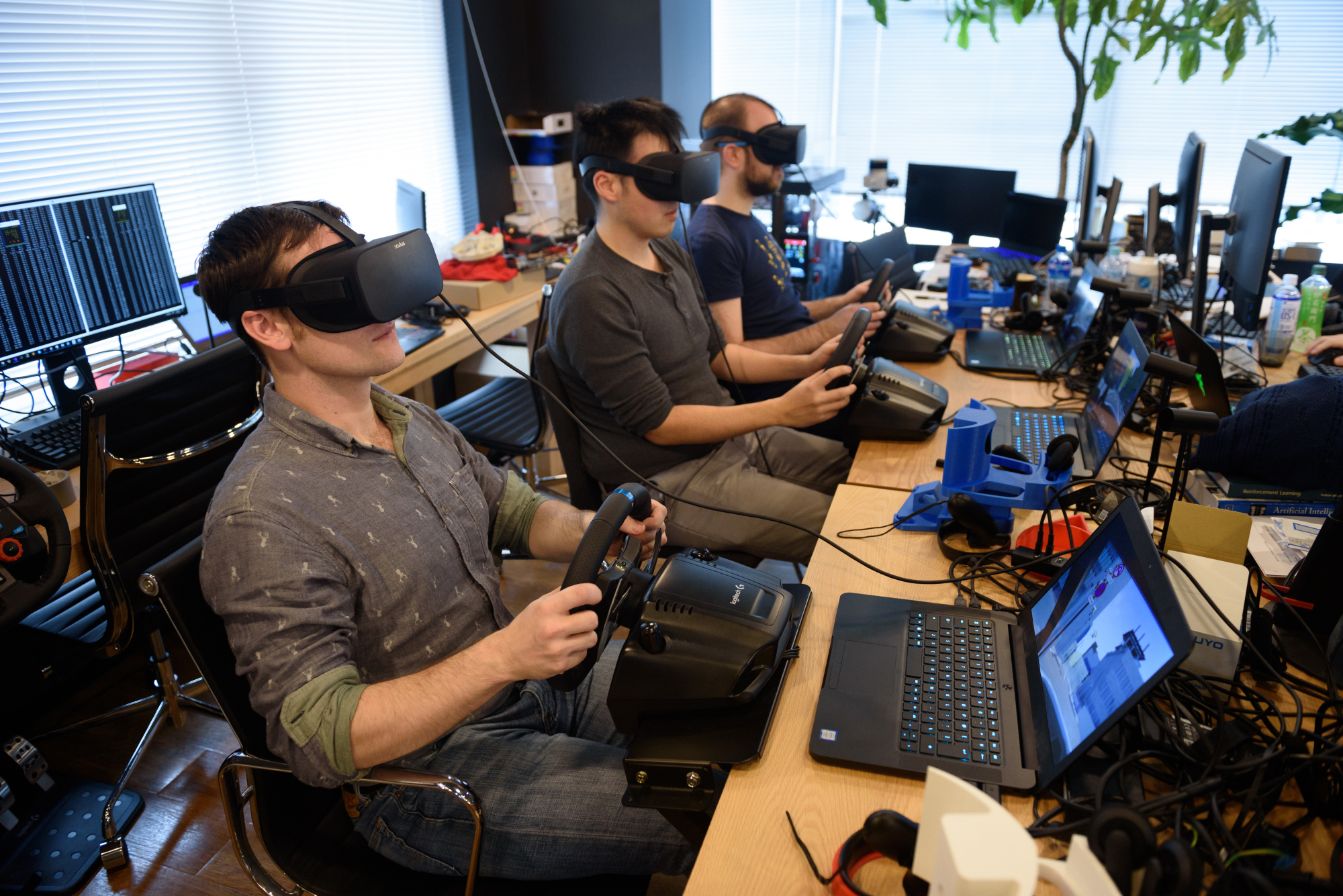 Employees at Ascent Robotics Inc. in Tokyo work on virtual simulation software for use in autonomous cars. To regain its international competitive edge, Japan must produce more engineers and scientists. | BLOOMBERG