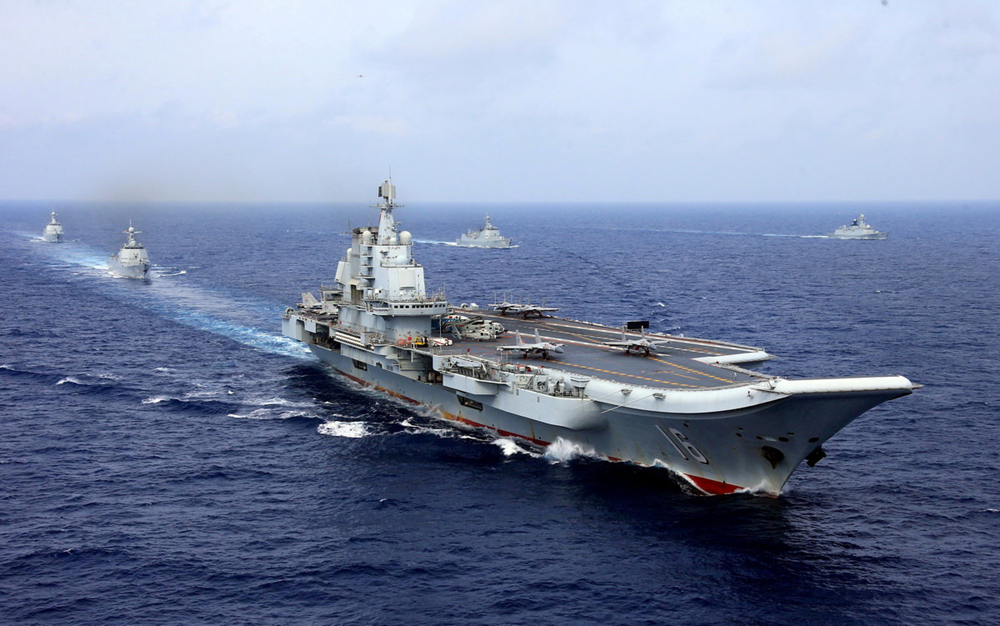 Chinese naval vessels led by the aircraft carrier Liaoning participate in a military exercise in the Western Pacific in April 2018. | REUTERS