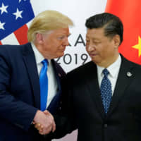 U.S. President Donald Trump greets Chinese President Xi Jinping at the start of their bilateral meeting at the G20 leaders summit in Osaka on Saturday. | REUTERS