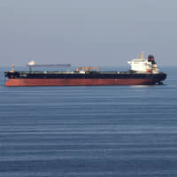 Oil tankers pass through the Strait of Hormuz last December. Japan faces a difficult question of whether to join escort operations in the waterways near Iran. | REUTERS