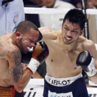 Challenger Ryota Murata punches champion Rob Brant in the second round of their WBA middleweight title fight on Friday at Edion Arena. | KYODO