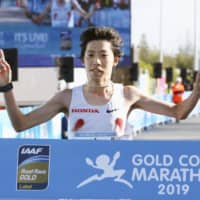 Yuta Shitara crosses the finish line to win the Gold Coast Marathon on Sunday in Gold Coast, Australia. | KYODO
