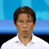 Akira Nishino, seen before Japan\'s match against Belgium during the 2018 World Cup, has been hired as head coach of Thailand\'s national and U-23 teams. | REUTERS