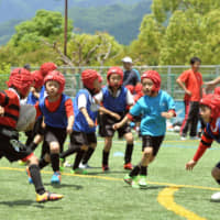 Rugby School of Ashiya students practice in Ashiya, Hyogo Prefecture, in June 2017. Wearing headgear is mandatory for children playing rugby  in Japan. | KYODO
