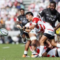 Kazuki Himeno of Japan passes the ball in the first half on Saturday against Fiji. | KYODO