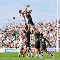 Japan (white and red) and Fiji vie for the ball in a lineout during the second half on Saturday. | KYODO