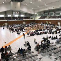 Sumo fans attend a regional tour stop in Uji, Kyoto Prefecture, in April. Sumo tours, or jungyō, allow fans in areas without tournaments to experience the sport up close. | JOHN GUNNING