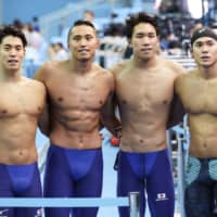 (From left) Akira Namba, Shinri Shioura, Katsuhiro Matsumoto and Katsumi Nakamura pose after their 4x100 men\'s freestyle relay heat at the swimming world championships on Sunday in Gwangju, South Korea. Their ninth-place finish earned Japan a berth in the event at the 2020 Tokyo Olympics. | KYODO