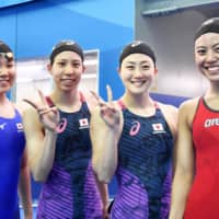 (From left) Rio Shirai, Aya Sato, Tomomi Aoki and Rika Omoto celebrate after setting a new national record of 3 minutes, 36.17 seconds in the women\'s 4x100 freestyle relay at the swimming world championships in Gwangju, South Korea, qualifying Japan for the event at Tokyo 2020 in the process. | KYODO