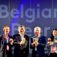 At Belgian Beer Weekend 2019 (which runs until July 7), Belgian Beer Weekend Committee Honorary Chairman and Belgian Ambassador Gunther Sleeuwagen (second from right) poses with Konishi Brewing Co. President and Belgian Beer Weekend Committee Chairman Shintaro Konishi (second from left), and BB Navigators Nele Duprix (far left) and Shiho Shingu during a Belgian beer toast at the event\'s opening ceremony at Tokyo\'s Hibiya Park on June 27. | HIROKO INOUE
