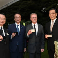 French Ambassador Laurent Pic (second from right) poses for a photo with (from left) Takeo Kawamura, vice-chairman of the Japan-France Parliamentary Friendship League; National Public Safety Commission Chairman and Minister of State for Disaster Management Junzo Yamamoto; and Japan Business Federation Vice Chairman Shuzo Sumi during a reception to celebrate France\'s national day at the ambassador\'s residence in Tokyo on July 14. | YOSHIAKI MIURA