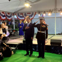 U.S. Ambassador William Hagerty (left) sings the American national anthem during a reception to celebrate the country\'s national day at the ambassador\'s residence in Tokyo on July 18. | MARIANGELES DEJEAN