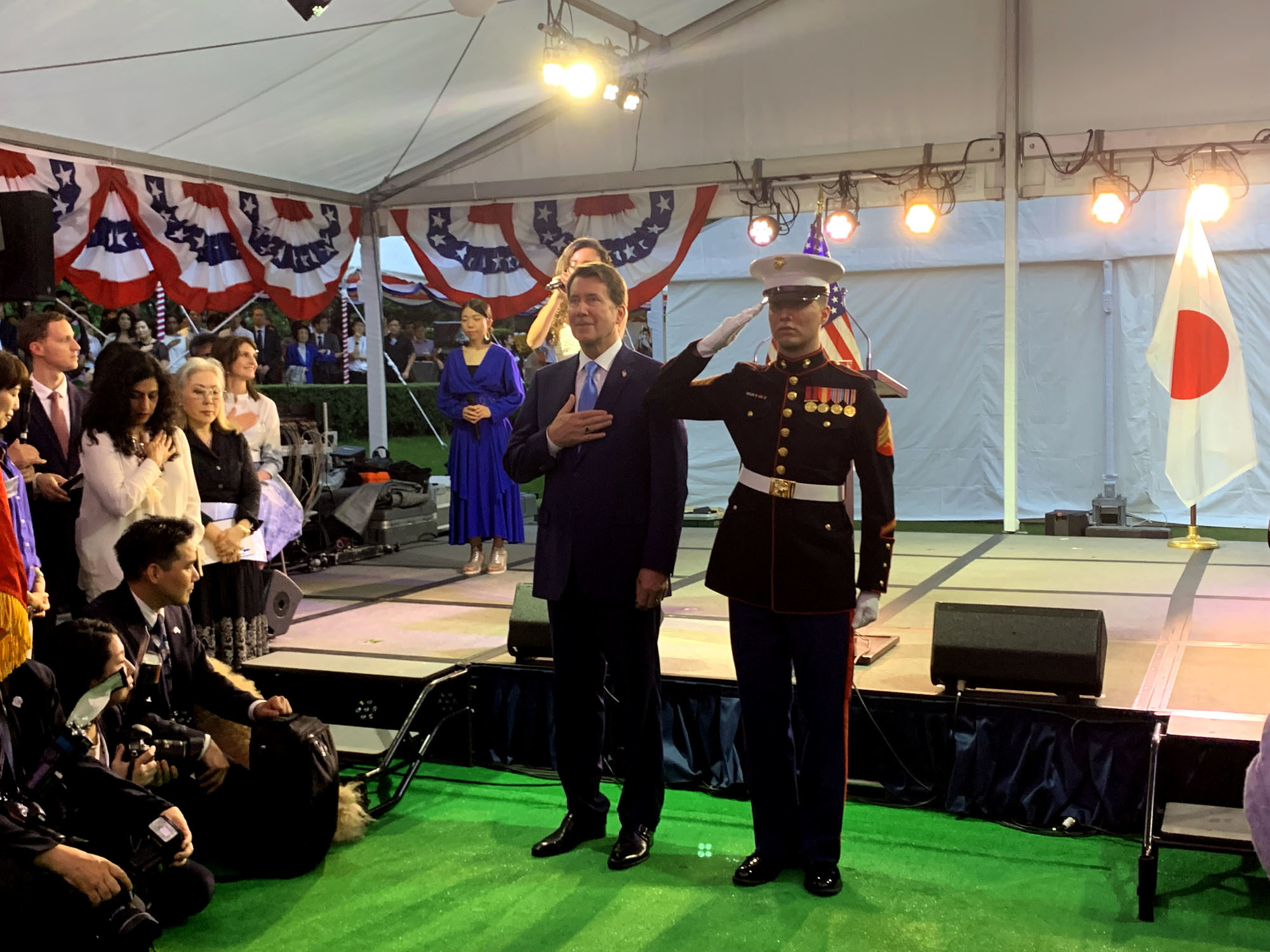 U.S. Ambassador William Hagerty (left) sings the American national anthem during a reception to celebrate the country's national day at the ambassador's residence in Tokyo on July 18. | MARIANGELES DEJEAN