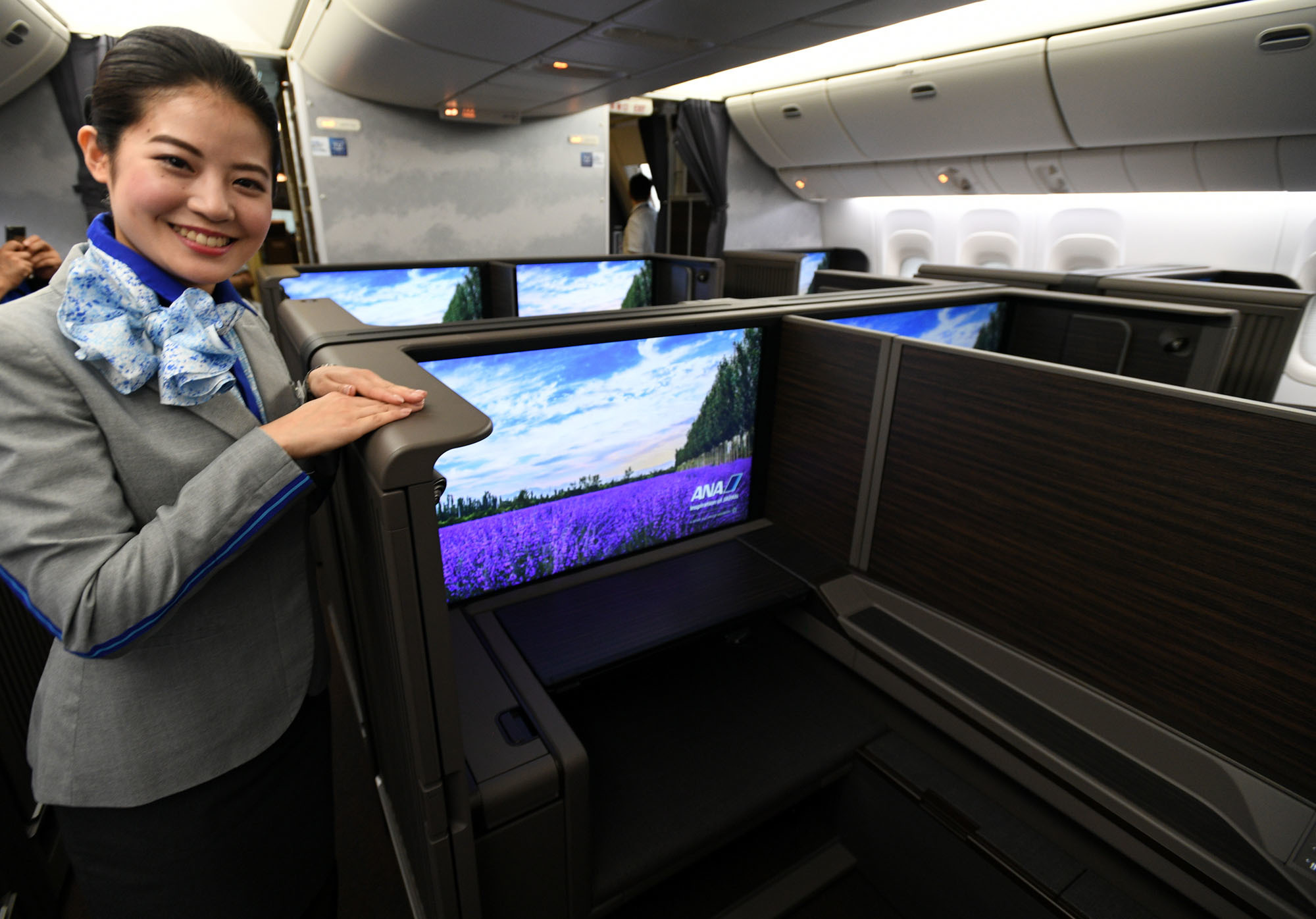 All Nippon Airways unveils first class cabins redesigned in collaboration with architect Kengo Kuma and leading British design firm Acumen, at Haneda airport in Tokyo on Thursday. The first of 12 redesigned Boeing 777-300ERs will fly the Tokyo-London route from Aug. 2. | YOSHIAKI MIURA