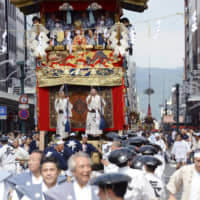 Yamahoko floats, the highlight of the Gion Festival, are paraded through the streets of Kyoto on Wednesday. About 120,000 spectators came to watch the traditional event, according to local police. The annual monthlong festival runs through July 31. | KYODO