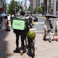An Uber Eats delivery person in Tokyo | KYODO