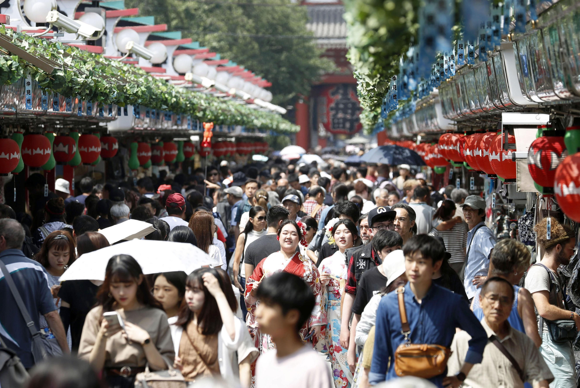 The Nakamise shopping street in the Asakusa district of Tokyo is crowded with tourists on July 17. | KYODO