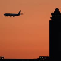 A Japan Airlines Co. passenger jet prepares to land at Narita Airport in Chiba Prefecture. | AKIO KON / BLOOMBERG