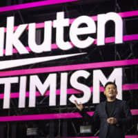 Hiroshi Mikitani, chairman and chief executive officer of Rakuten Inc., speaks during the Rakuten Optimism conference in Yokohama on July 31. | BLOOMBERG