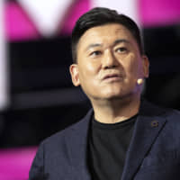 Hiroshi Mikitani, chairman and CEO of Rakuten Inc., speaks at the Rakuten Optimism conference in Yokohama on Wednesday. The business conference focusing on 5G innovation will end on Saturday. | BLOOMBERG