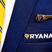 The Ryanair logo is pictured on the the jacket of a cabin crew member ahead of a news conference by Ryanair union representatives in Brussels last September. | REUTERS