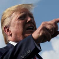 U.S. President Donald Trump speaks to reporters before boarding Air Force One to return to Washington from Morristown Municipal Airport in Morristown, New Jersey, Sunday. | REUTERS