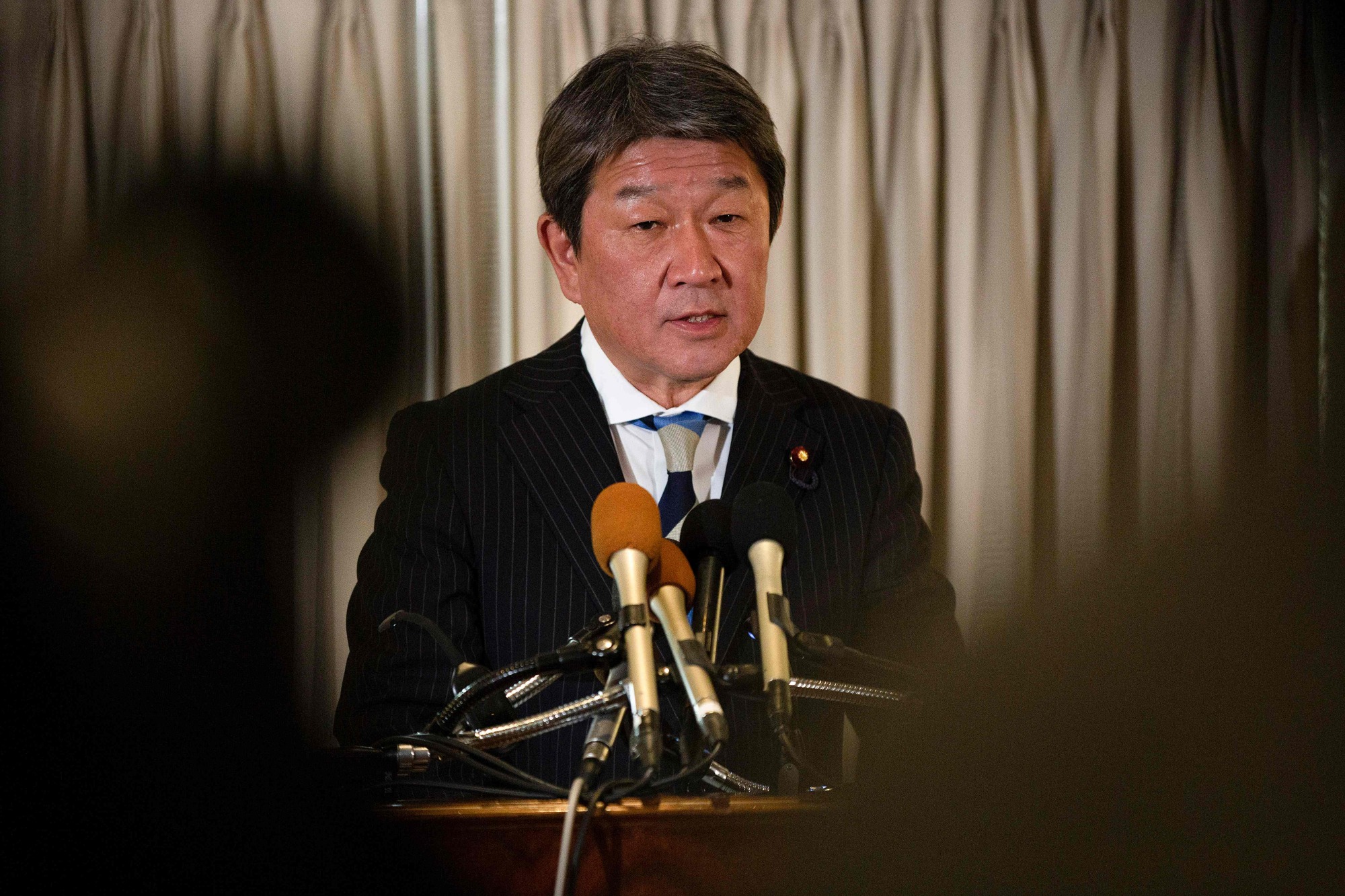 Economic revitalization minister Toshimitsu Motegi speaks during a news conference at a hotel in Washington on Friday. | AFP-JIJI