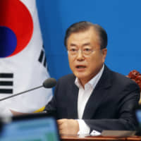 South Korean President Moon Jae-in speaks during an emergency cabinet meeting at the presidential Blue House in Seoul, Friday. Moon has vowed stern countermeasures against Japan\'s decision to downgrade its trade status, which he described as a deliberate attempt to contain South Korea\'s economic growth and a \"selfish\" act that would damage global supply chains. | AP