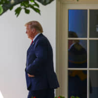 U.S. President Donald Trump walks out of the Oval Office for travel to the AMVETS convention in Kentucky from the South Lawn of the White House in Washington Wednesday. | REUTERS