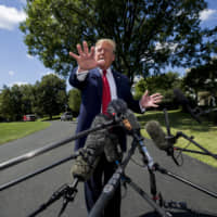 President Donald Trump speaks with reporters before departing on Marine One on the South Lawn of the White House Wednesday in Washington. | AP
