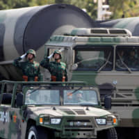 Chinese soldiers salute in front of missile launchers during a parade in Beijing. The event in 2009 marked the 60th anniversary of the founding of the People\'s Republic of China in Beijing. | REUTERS