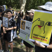 People gather in Lafayette Square in front of the White House in Washington Sunday in solidarity with the \"Stand With Hong Kong, Power to the People Rally\" in Hong Kong. | AP