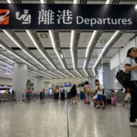A passenger walks at the departure hall of Hong Kong\'s West Kowloon Terminus, which connects the city to mainland China by rail, on Tuesday. Britain\'s Foreign Office said Tuesday it was \"extremely concerned\" by reports that a Hong Kong consulate employee had been detained by mainland Chinese authorities on his way back to the city. | AFP-JIJI